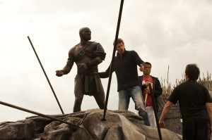 Adewale Akinnuoye-Agbaje takes direction from Paul W.S. Anderson. Photo by Caitlin Cronenberg.