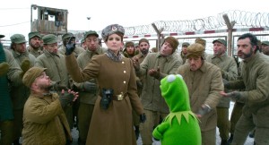 Kermit becomes fast friends with WWE's Hornswoggle, Nadya (Tina Fey) and others in "Muppets Most Wanted".